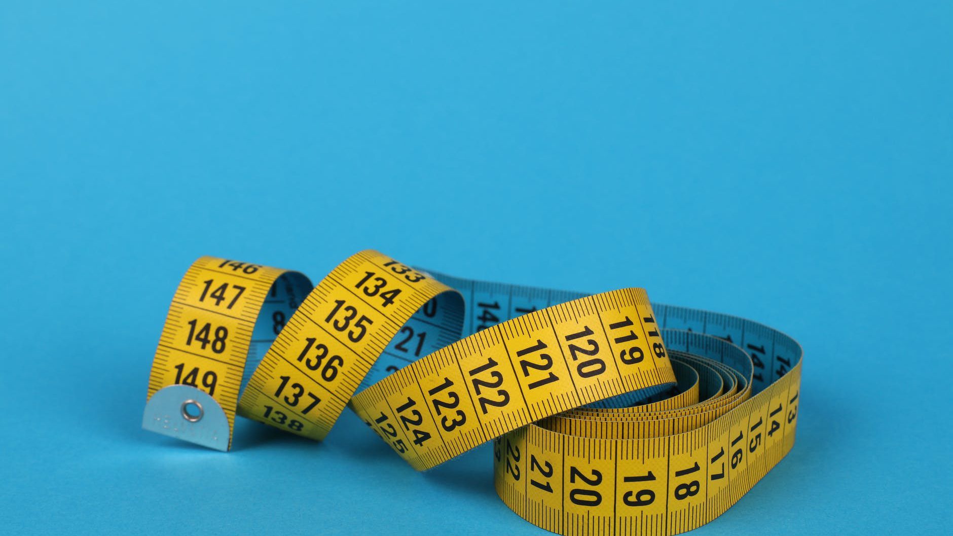 yellow tape measure on blue background