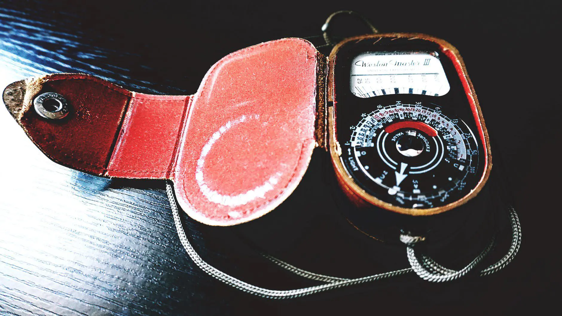 analog device on black wooden surface