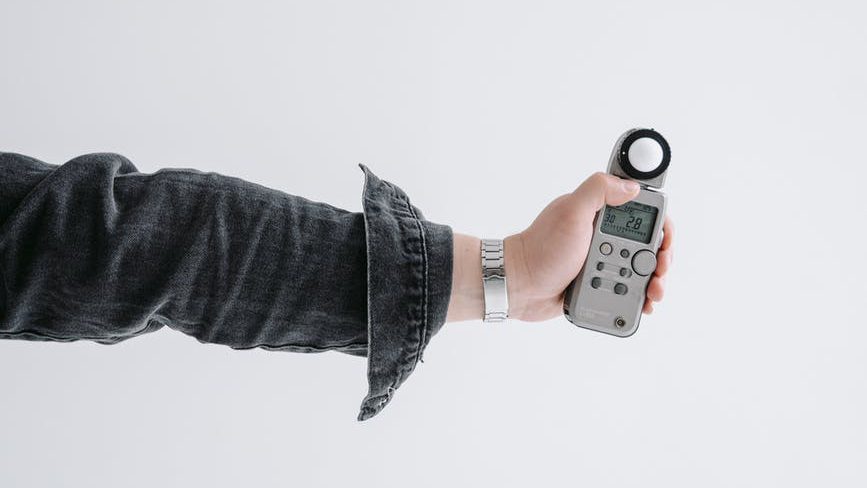 a person holding a light meter