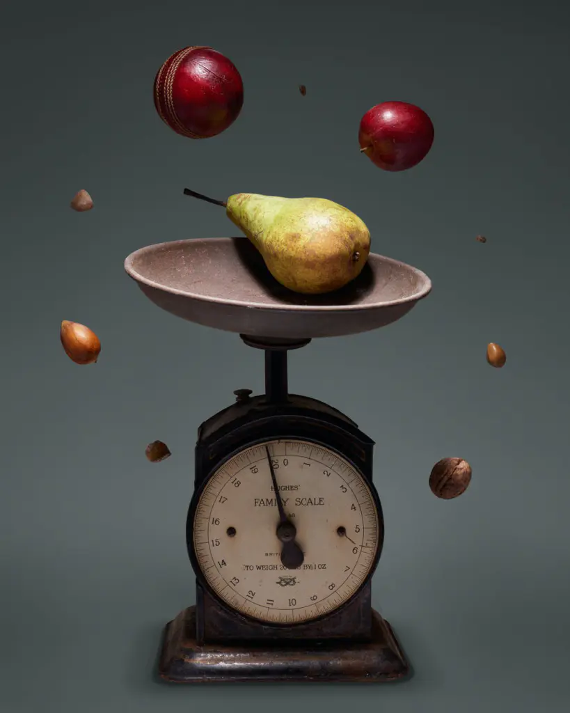 yellow and red round fruit on brown and white weighing scale